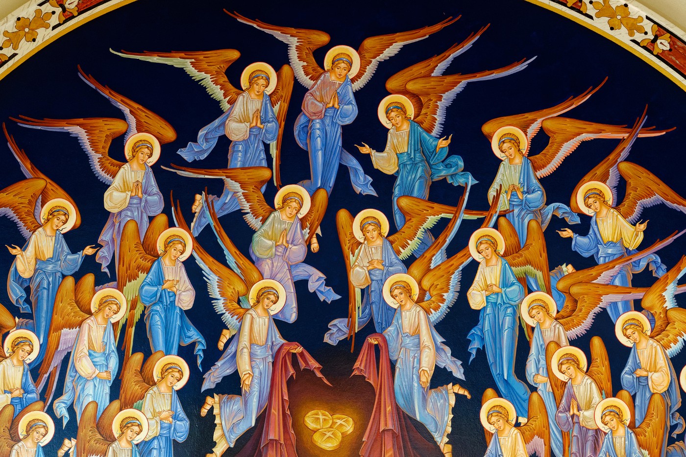 Fresco of a group of angels in adoration and prayer in heaven.